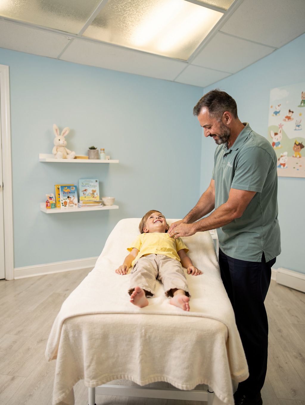 Chiropractor performing a gentle adjustment on a happy infant